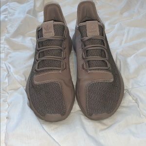 Pink and tan Adidas tennis shoes